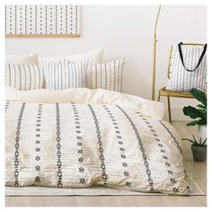 a white bed with black and white patterns on it