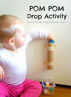 an image of a baby playing with toys on the floor and text that reads pom pom drop activity