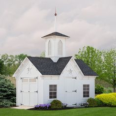 a small white church with a black roof