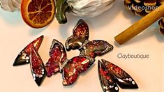 several pieces of glass sitting on top of a table next to oranges and pine cones