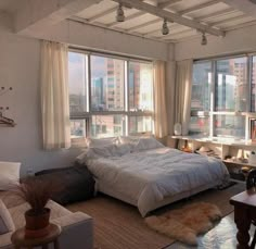 a bed sitting in a bedroom next to a window filled with lots of windows and furniture