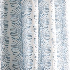 a blue and white curtain with leaves on it