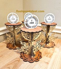 four clocks sitting on top of each other in the middle of a wooden flooring area