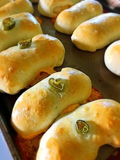 some bread rolls with green peppers on them