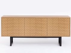 the sideboard is made out of wood and has black legs, with geometric patterns on it