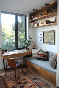 a living room with a couch, desk and bookshelf next to a window