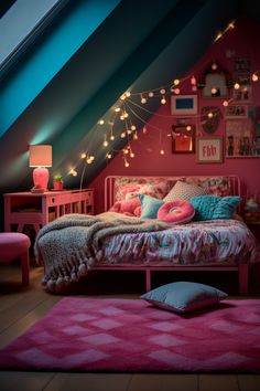 an attic bedroom decorated in pink and blue with lights on the wall above the bed