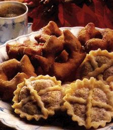 several pastries are on a plate next to a cup of coffee