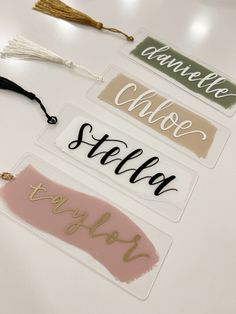 three different name tags with tassels on them