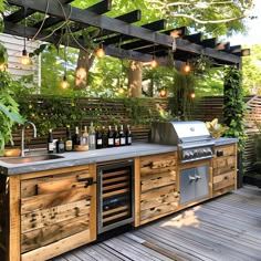 an outdoor kitchen with lots of bottles on the counter and lights hanging from the ceiling