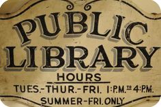 an old public library sign hanging on the wall