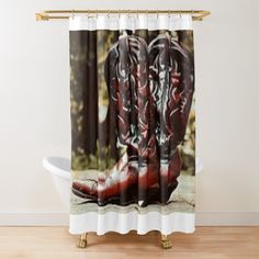 a pair of cowboy boots sitting on the ground shower curtain