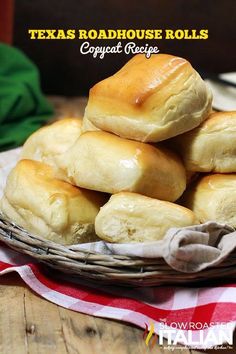 a basket filled with rolls sitting on top of a wooden table