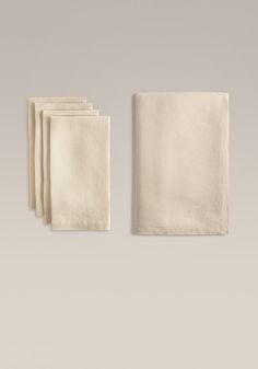 four white napkins are sitting next to each other