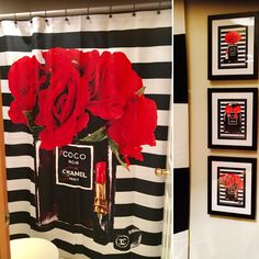 a bathroom decorated in black and white with red roses