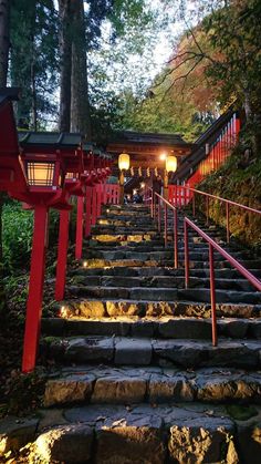 the stairs lead up to an area with lanterns on them