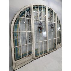 an old arched window with stained glass panels