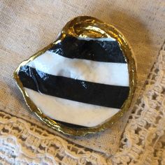 a black and white striped brooch with gold trim