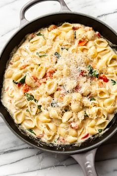 a skillet filled with pasta and cheese