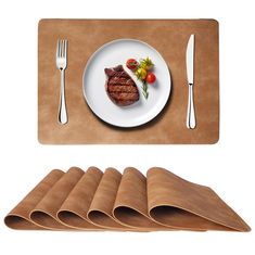 a plate with steak and vegetables on it next to placemats