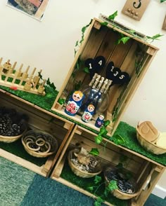 an assortment of items displayed in wooden crates with moss growing on the top and bottom