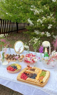 a table topped with lots of different types of foods and desserts on top of it