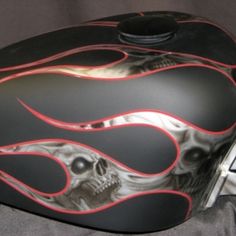 a motorcycle helmet with flames and a skull on it