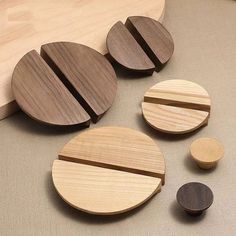 three wooden coasters sitting next to each other on top of a table with wood circles around them