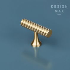 an image of a gold metal object on a blue background with the words design max above it