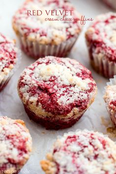 red velvet creme cheese muffins are shown on a baking sheet with the rest of the muffins covered in powdered sugar