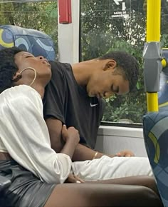 a man and woman sitting on a bus together