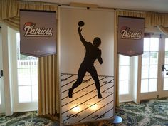 a man is playing basketball in front of two large banners with the words detroit's on them