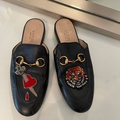 Gucci Women’s Princeton Leather Slipper, Limited Edition. Embellished Lion, Heart Design. Size 35. Used. Designer Gucci Slip-on Leather Shoes, Gucci Slip-on Mules, Gucci Slip-on Mules With Leather Sole, Luxury Gucci Slip-on Mules, Luxury Gucci Slip-on Slides, Gucci Princetown, Lion Heart, Gucci Women, Shoes Gucci