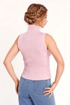 Introducing our Knitted Baby Pink Top Without Sleeves – a chic and versatile addition to your wardrobe. This pink top, featuring a high neck and sleeveless style, is designed to bring a touch of elegance to your daily attire.  The turtleneck neckline adds sophistication, while the bodycon fit ensures a flattering silhouette that seamlessly complements various outfits. Whether you choose to wear it alone or pair it with a blazer, this top is a versatile piece for your daily wardrobe.  Crafted from fine knit with a composition of 55% Viscose and 45% Polyamide, this top offers a soft and comfortable feel against your skin. The model is showcasing the size S, and with her measurements (33-24-35, Height: 5'9''), you can visualize the stylish fit of this top.  Please note that this top runs smal Spring Turtleneck Stretch Tank Top, Spring Stretch Turtleneck Tank Top, Stretch Turtleneck Tank Top For Spring, Chic Ribbed Funnel Neck Top, Chic High Neck Tops With High Stretch, Chic Spring Knit Turtleneck, Chic Knit Turtleneck For Spring, Pink Fitted Knit Top, Chic Pink Knit Top