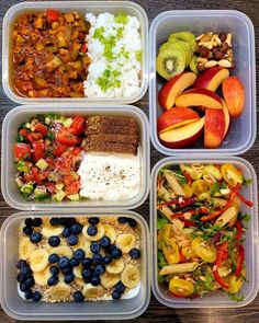 four plastic containers filled with different types of food on top of a wooden table next to an apple