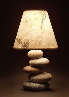 a lamp sitting on top of a pile of rocks