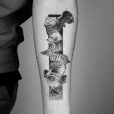 a black and white photo of a person's arm with a tattoo on it