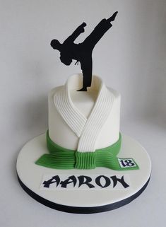 a cake with a person doing a trick on it's top and the words aaron written in black