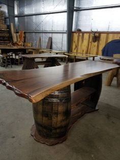 a large wooden table sitting inside of a building