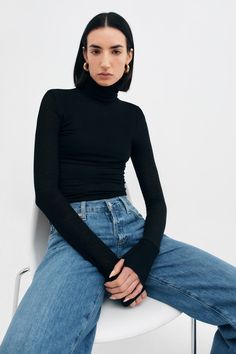 Meet Eloise, our turtleneck providing dream tailoring with lasting comfort. Casual yet effortless to dress up, she's a truly versatile staple for your closet. Handcrafted from our soft, high-stretch and sustainable European jersey, she features thumbhole sleeves and our standard extra length around the torso. Eloise is also available in our sheer jersey. | Emily, in black, is 5'9.5" (177 cm) tall, wearing size XS. Sam, in black, is 5'8" (173 cm) tall, wearing size XS. Total length is approximate Turtle Neck Outfit Women, Turtle Neck Outfit, Gap Style, Red Turtleneck, Fitted Turtleneck, Sweatshirt Fabric, Turtleneck Top, Black Turtleneck, Long Sleeve Turtleneck