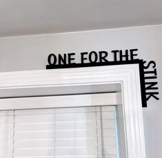 the word one for the stars is placed on top of a window sill in a white room