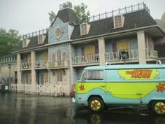 a van parked in front of a building on a rainy day