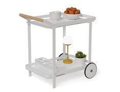 a white cart with some food on it and a bowl of oranges next to it