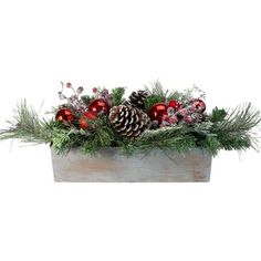 a wooden box filled with christmas decorations and pine cone balls on top of evergreen branches