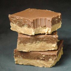 three pieces of chocolate peanut butter bars stacked on top of each other