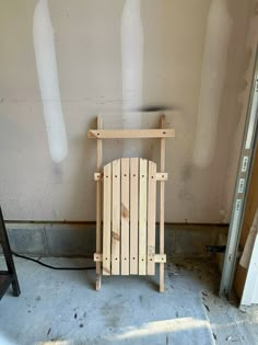 a chair made out of wooden pallets sitting in a room next to a wall