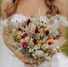 a bride holding a bouquet of flowers in her hands