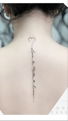 the back of a woman's neck with a tattoo that reads, i love you