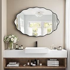 a white sink sitting under a mirror in a bathroom