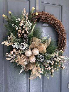 a wreath on the front door with pine cones and berries